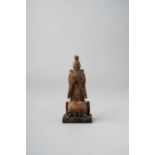 A JAPANESE WOOD FIGURE OF A SHINTO DEITY PROBABLY EDO, 16TH CENTURY OR LATER The kami is depicted