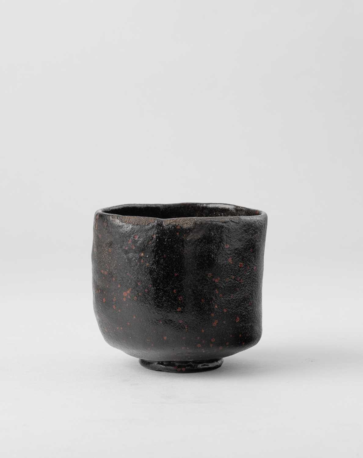 A JAPANESE BLACK RAKU CHAWAN (TEA BOWL) EDO PERIOD, 18TH-19TH CENTURY The tall cylindrical body