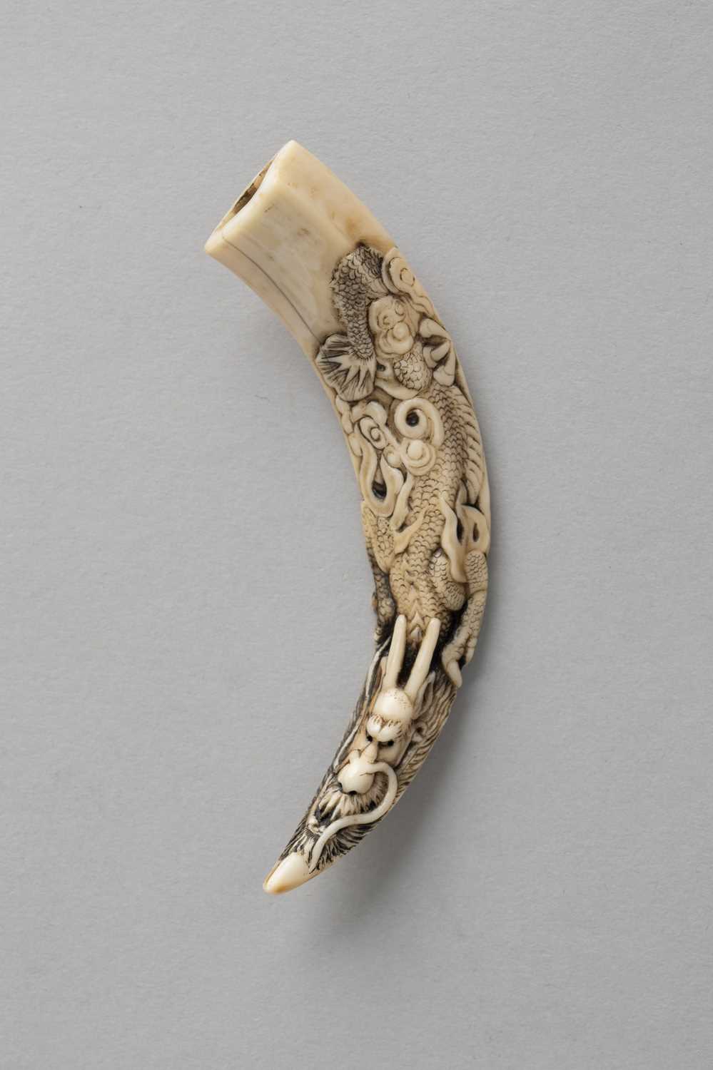 A JAPANESE IWAMI-STYLE BOAR TUSK NETSUKE HEISEI OR REIWA, 20TH OR 21ST CENTURY Carved to one side