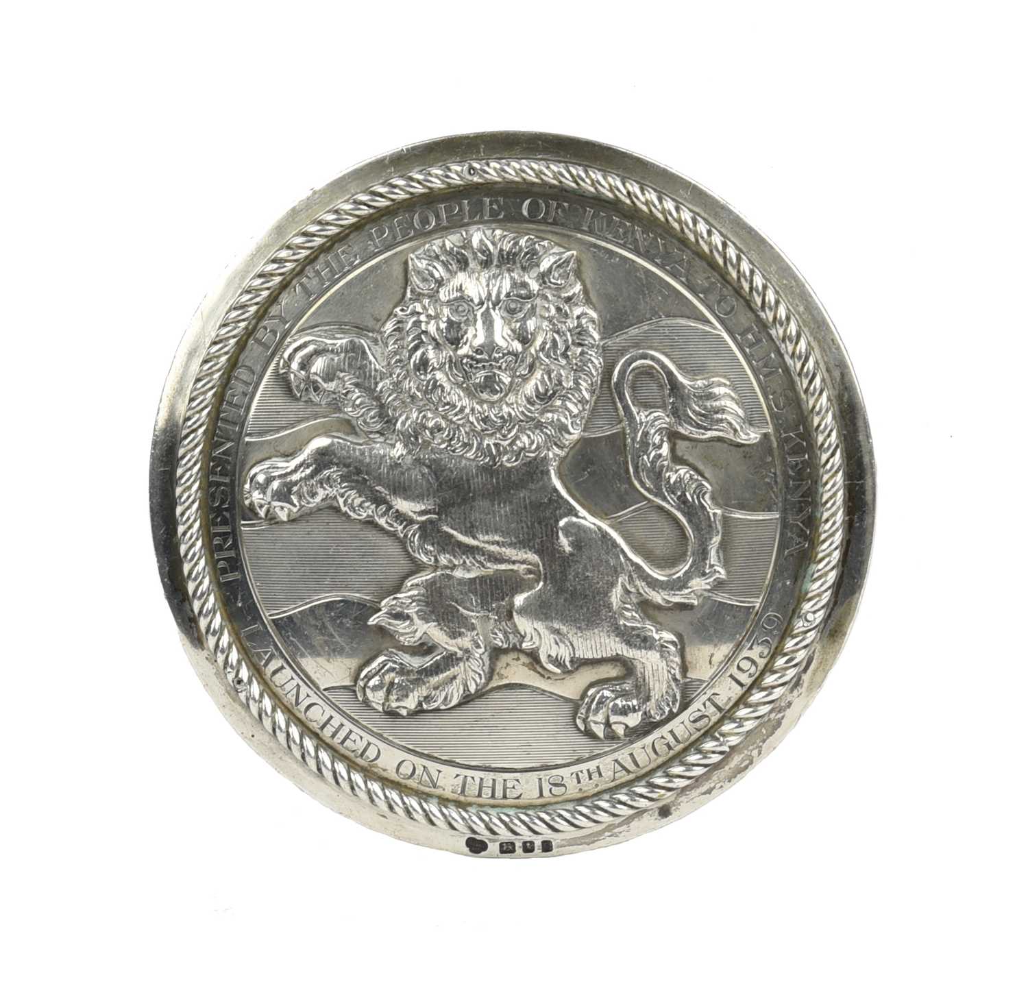 H.M.S. Kenya: a silver tompion plate, of circular form, applied lion rampant guardant against