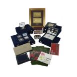 A quantity of overseas proof coin sets, silver stamp issues, a framed pair of gold leaf bank