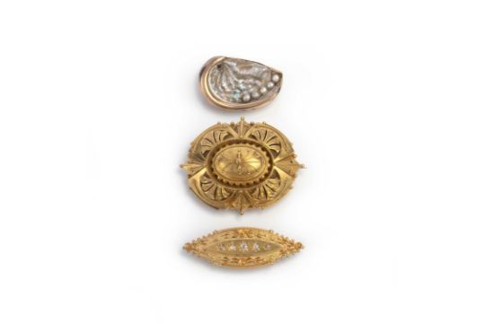 Three gold brooches, late 19th/early 20th century, comprising: a gold brooch of oval outline,