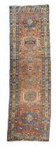 A HERIZ RUNNER NORTH WEST PERSIA, C.1910 the terracotta field with a column of latch hook and