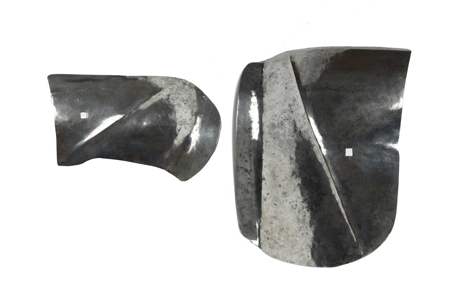 A pair of 15th century Milanese gardbraces, of hammered steel, the larger left-hand plate with