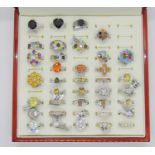 Collection of gem set silver dress rings, to include several multi gem rainbow cluster examples,