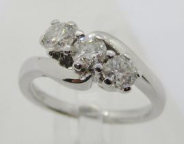 18ct white gold three stone diamond crossover ring, each stone 0.20ct approx, maker 'RG', size J/