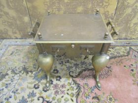 Victorian brass rectangular footman, with shaped outline and swept forelegs