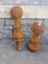 A pair of weathered cast iron post cap finials, 40 cm high ( af one lacks socket)