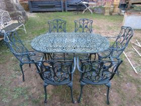 A contemporary painted cast alloy seven piece terrace set with pierced and scrolling foliate detail,