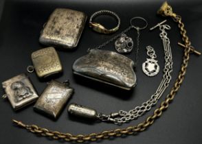 A selection of silver including a cigarette case, two vestas, a silver chain and vinaigrette,