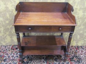 An early Victorian mahogany washstand raised on turned supports with box base, frieze drawer and