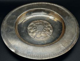 A silver plate with central rose decoration, London 1968, maker Tessiers Ltd, 17 cm diameter, a