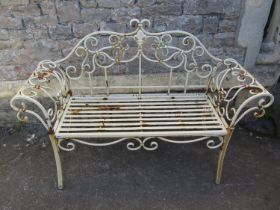 A decorative contemporary weathered painted light steel two seat garden bench with open scrollwork