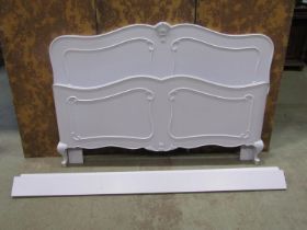 A continental wooden Bed stead with shaped outline, applied mouldings and later painted finish (