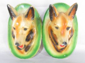 A pair of painted chalk Alsatian wall plaques, 31cm