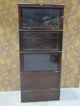A vintage four sectional floorstanding four sectional stacking library bookcase in the Globe
