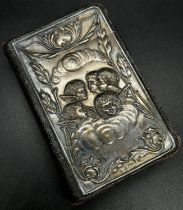 An English Common Prayer Book with a silver mounted front cover of angels amongst clouds