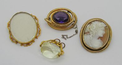 Group of antique yellow metal jewellery comprising a 9ct brooch with scrolled frame, a citrine