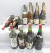 Eight bottles of vintage red wine, indistinguishable distressed labels, one bottle of 1985