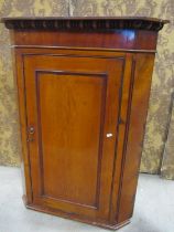 A Georgian pale oak and mahogany veneered hanging corner cupboard enclosed by a rectangular