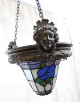 An early 20th century style glass hanging light shade of “leaded” panels with flowers suspended from