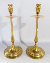 A pair of 19th century brass candlesticks with slender column supports