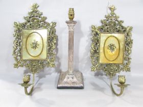 A pair of Renaissance style brass wall sconces decorated with masks and serpents amongst the