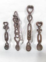 Four Welsh love spoons, intricately carved.