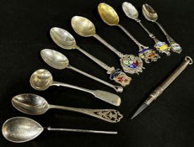 Nine assorted silver souvenir spoons, a silver wine coaster and a pencil casing