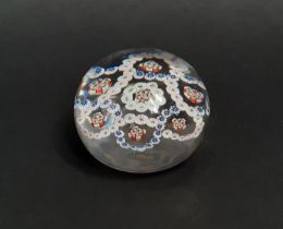 A mid 19th century Baccarat clear glass millefiori paperweight with rings of coloured cane and