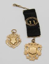Edwardian 9ct mounted ribbon fob with medal inscribed 'Edwin Bibby for General Excellence', 14.5g