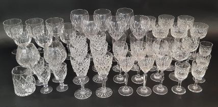 A large suite of mixed cut glass wine glasses in varying styles and sizes