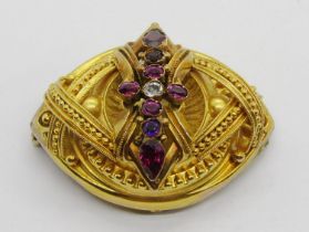 Victorian yellow metal Etruscan Revival style brooch set with garnets, 4.6cm W approx, 12.5g