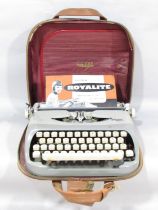 A Royalite portable typewriter circa 1960’s, made by Royal, in its original case and with