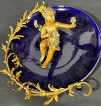 19th century continental blue ceramic wall plate, the blue ceramic dish surmounted by trailing