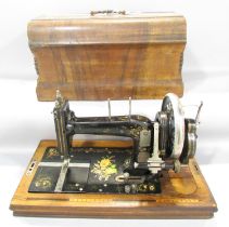 A German Winnselmann manually operated sewing machine, with floral decorations with its original