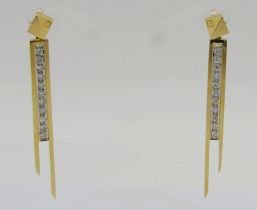 Pair of stylised contemporary 18ct asymmetrical drop earrings set with a line of diamonds, 5.4cm L