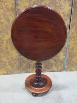 A Victorian Mahogany snap top occasional table of circular form with moulded outline raised on a