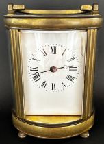 Brass carriage clock with oval shaped case and eight day time piece