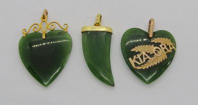 Three antique 9ct carved New Zealand nephrite pendants to include a heart shaped 'Kia Ora'