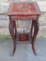 An oriental lacquered two tier occasional/lamp table with scrolling dragon, butterfly and