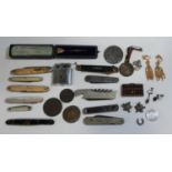 A collection of vintage pen knives, Victorian medallions, tiny wooden abacus and cabinet items