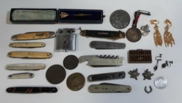 A collection of vintage pen knives, Victorian medallions, tiny wooden abacus and cabinet items