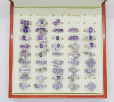 Collection of purple - violet gem set silver dress rings, to include amethyst, tanzanite, opal,