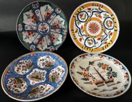 Four 19th century continental tin glazed Delft dishes with geometric floral detail