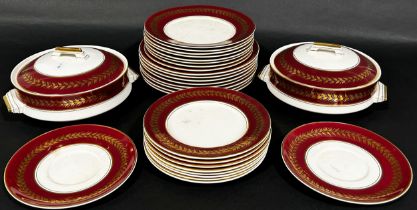 A Palissy Pottery dinner services for eight with red ground and gilt banded borders, comprising