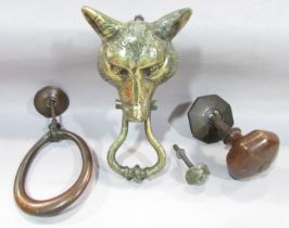 A brass fox head door knocker, a simple loop/horse shoe door knocker and a bronze door handle.