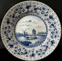 Large Delft charger the central panel showing a fishing boat with distant landscape including a