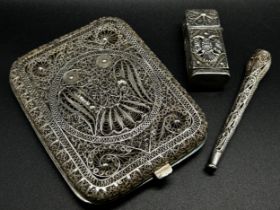 A fine Filigree silver cigarette case from India, together with a matching lighter and cigarette