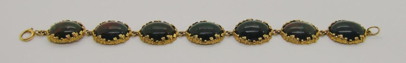 Stylised vintage 9ct bracelet set with seven oval cabochon bloodstones, 18.5cm L approx, 24.8g